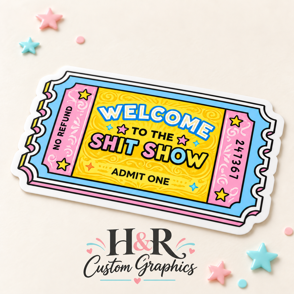 A colorful novelty ticket graphic with the text 'WELCOME TO THE SHIT SHOW' and 'ADMIT ONE' on a yellow center panel, surrounded by pink and blue border sections. The ticket is shown on a light beige background with scattered pastel star confetti and a visible 'H&R Custom Graphics' logo below.
