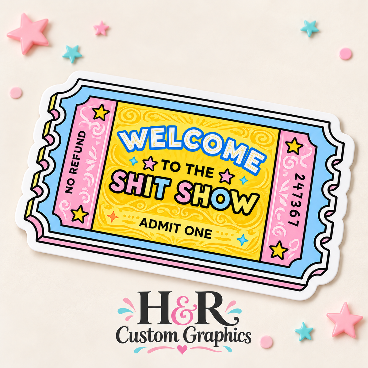 A colorful novelty ticket graphic with the text 'WELCOME TO THE SHIT SHOW' and 'ADMIT ONE' on a light beige background with decorative pastel star confetti. The brand name 'H&R Custom Graphics' appears below the ticket.