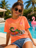 Hotter Than a Hoochie Coochie graphic t-shirt featuring a lounging alligator on a pool float with retro summer typography on a neon coral tee.