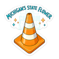 A die-cut sticker featuring a cartoon orange and white traffic cone with the text 'MICHIGAN'S STATE FLOWER' in blue arched above it, plus small star accents, shown on a white background.