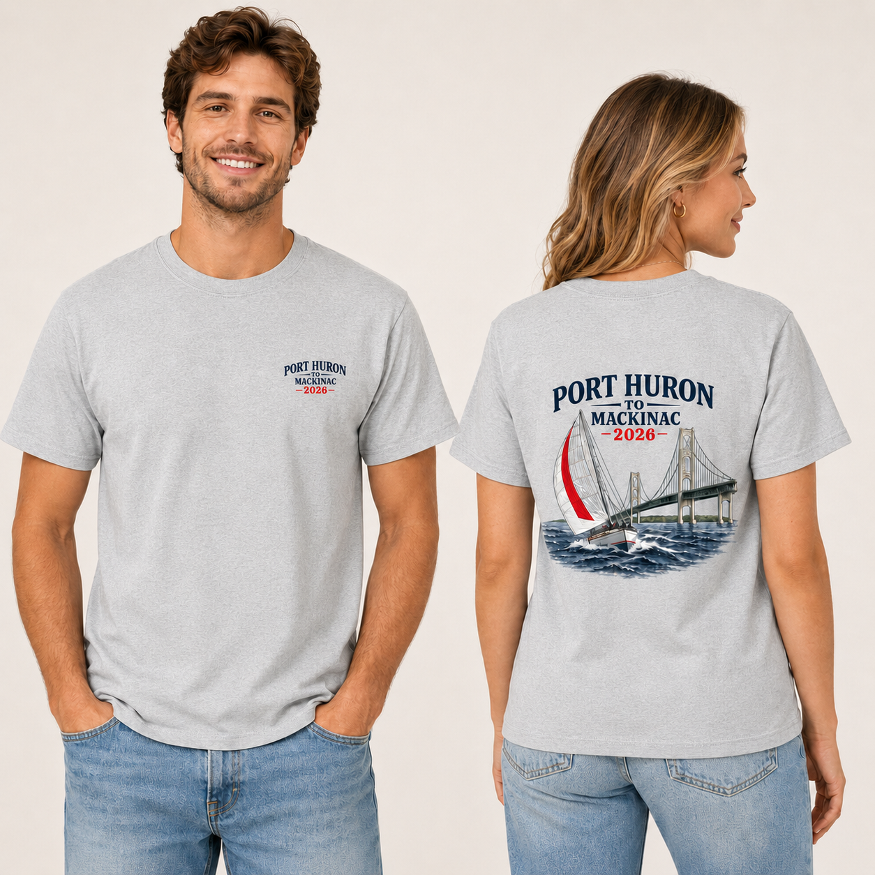 Male and female models wearing grey Port Huron to Mackinac 2026 race shirts, showing the front left chest logo and large sailboat bridge back design.