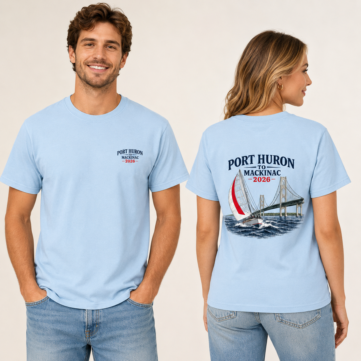 Male and female models wearing light blue Port Huron to Mackinac 2026 race shirts, showing the front left chest logo and large sailboat bridge back design.