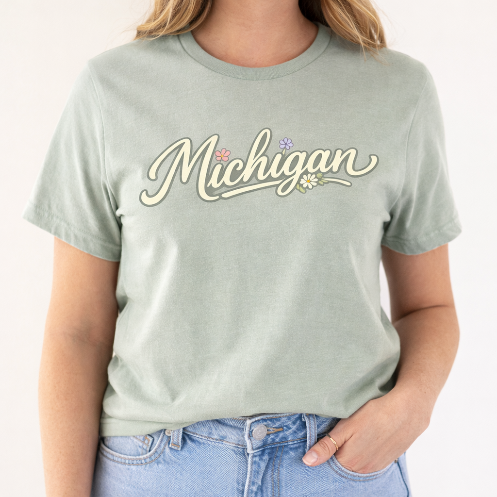Person wearing a light green t-shirt with 'Michigan' printed on it, standing against a plain background.