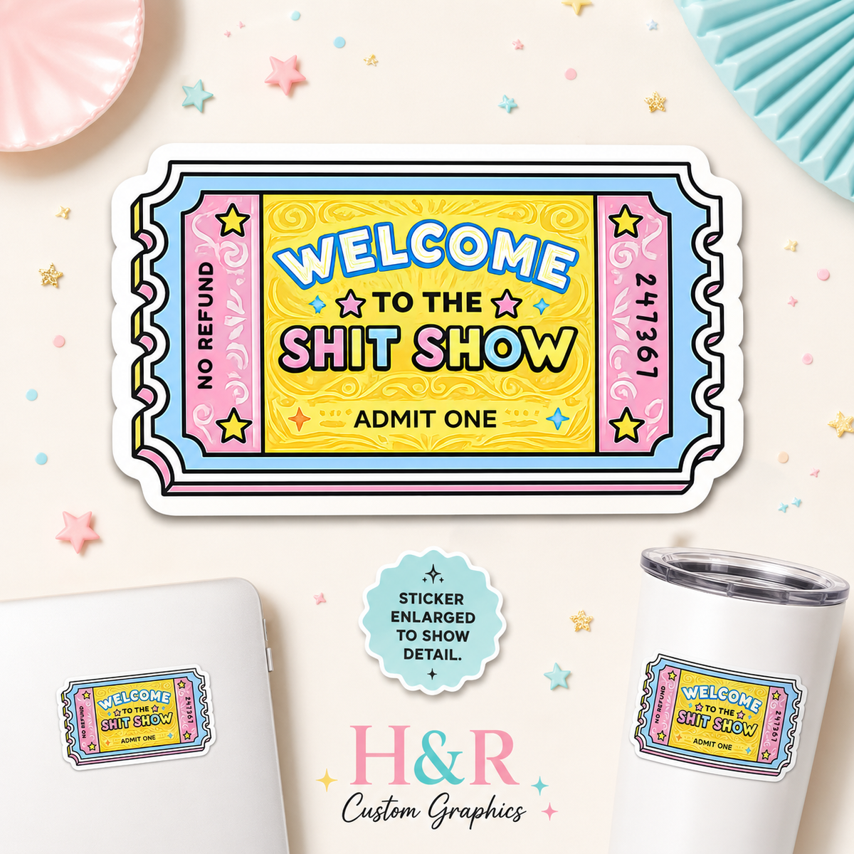 A colorful novelty ticket-shaped sticker reading “Welcome to the Shit Show” and “Admit One,” shown on a light cream background with decorative confetti, a tumbler, a laptop, and a small badge that says the sticker is enlarged to show detail. The brand name H&R Custom Graphics appears at the bottom.